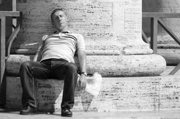 Taking a nap against a pillar